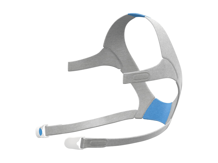 Arnés de tela gris con correas ajustables y clips blancos